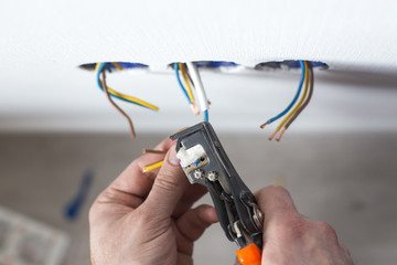 An electrician stripping wire for new construction
